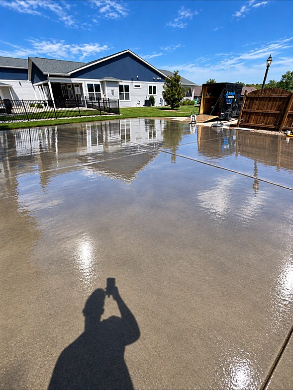 The same apron after washing, clean and still wet enough to mirror the building