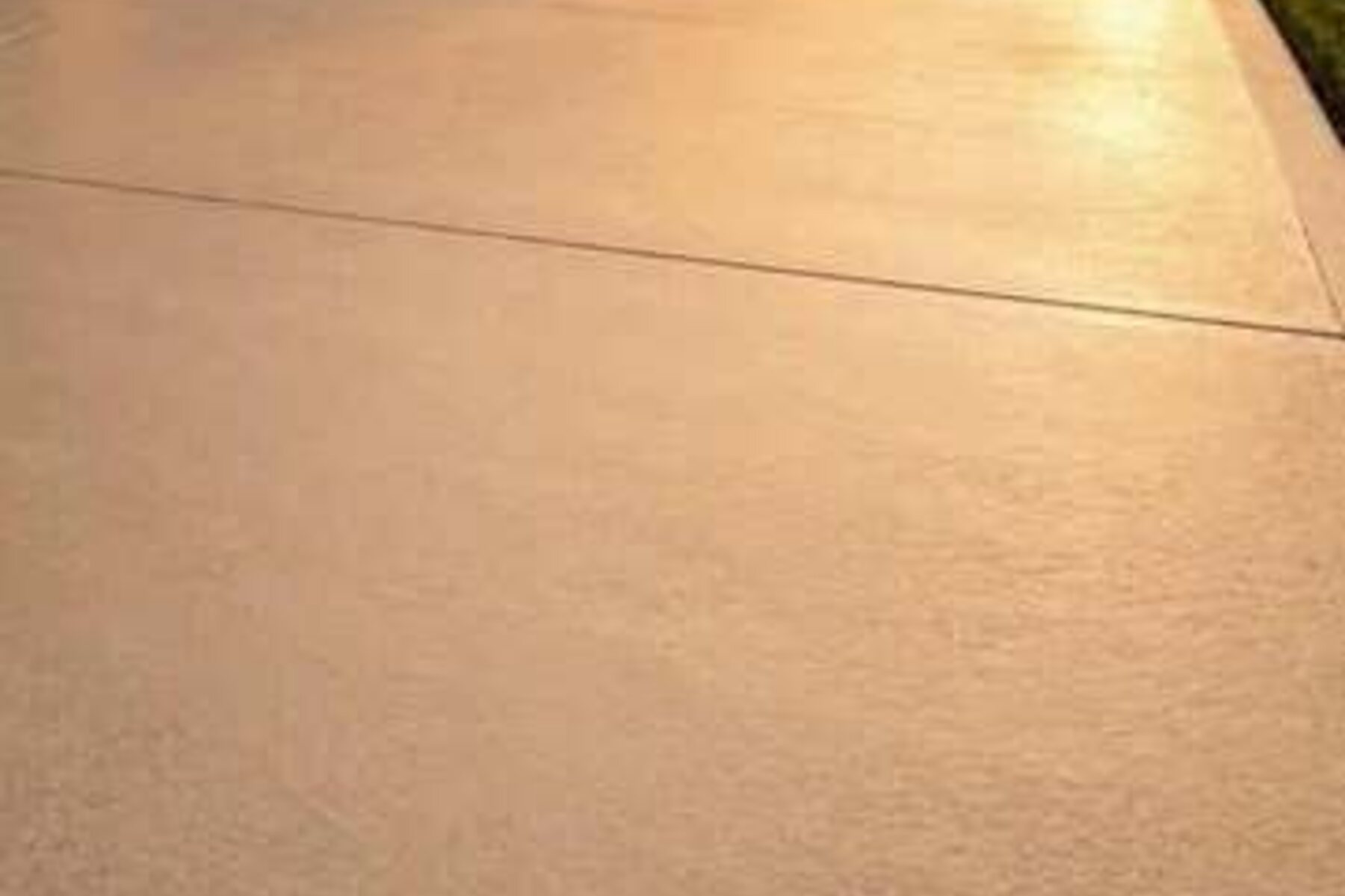 A freshly cleaned concrete driveway at golden hour