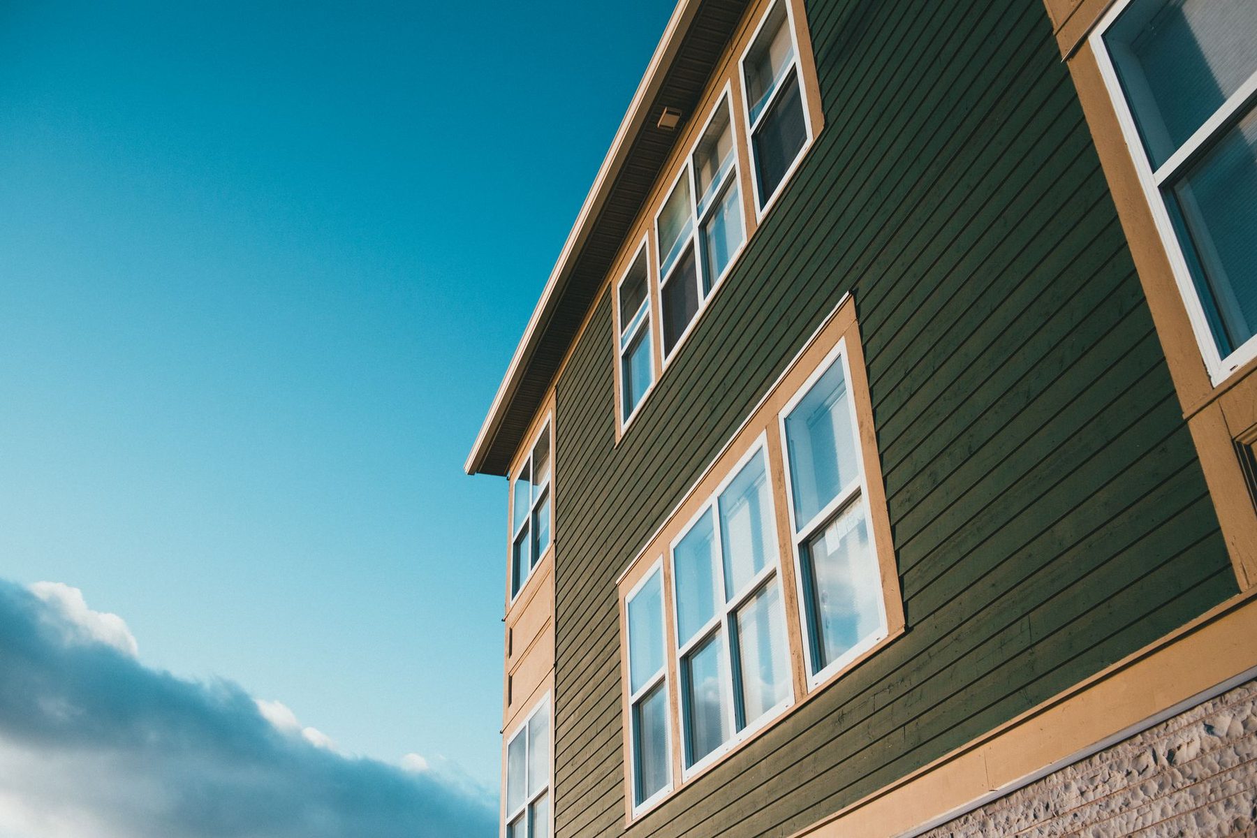 Clean painted siding and trim on a two-storey home
