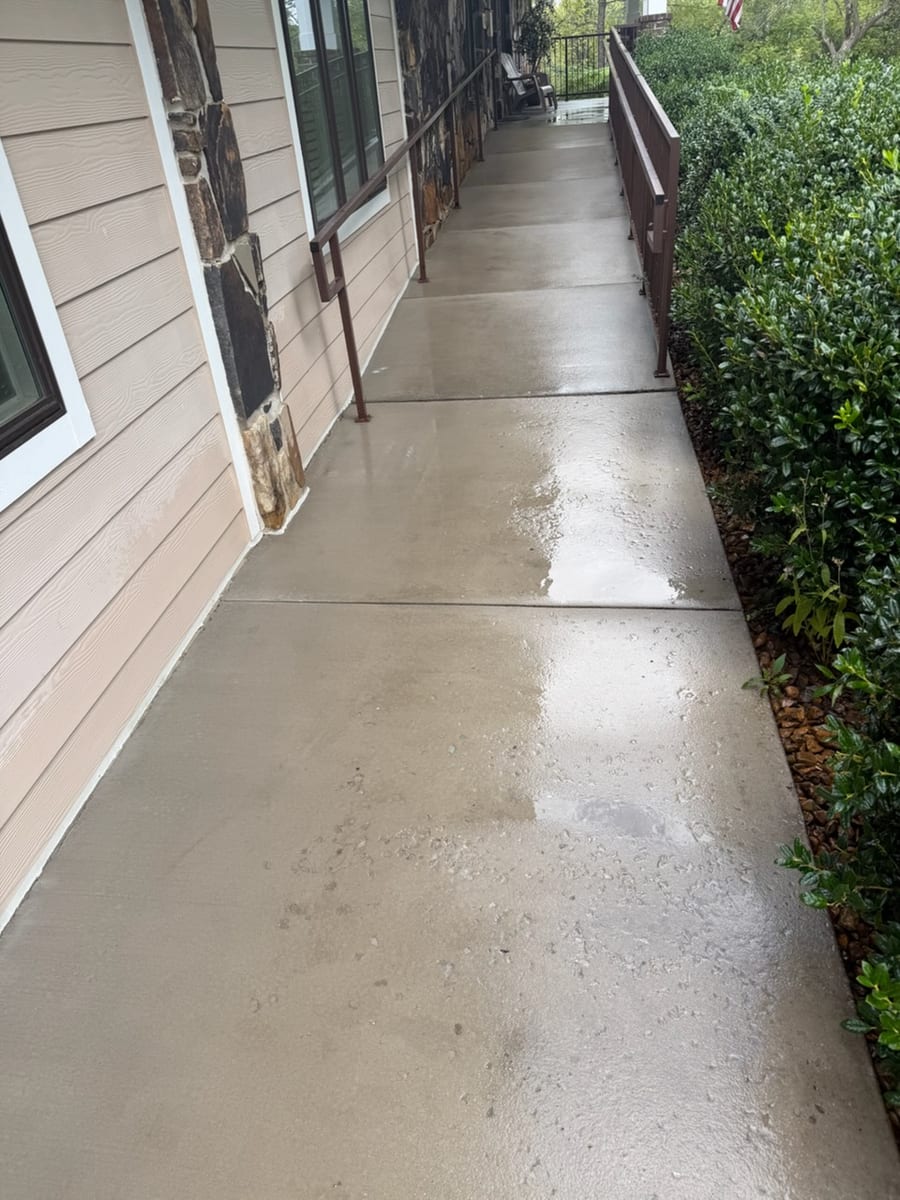 The same covered walkway after hot water washing, clean and even along its whole length